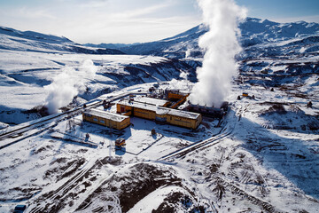 Aerial view to geothermal power plant in mountain. Clean green renewable energy in Kamchatka.