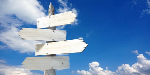 Wooden signpost with four clear arrows © PX Media