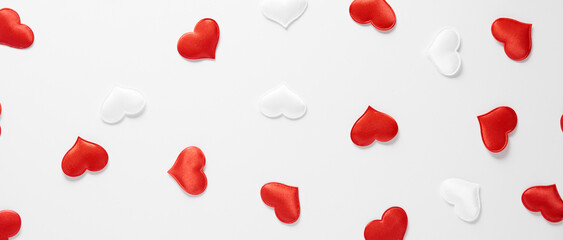 Red and white silk hearts isolated on white background. Valentine's day or Wedding romantic concept, top view, copy space, flat lay