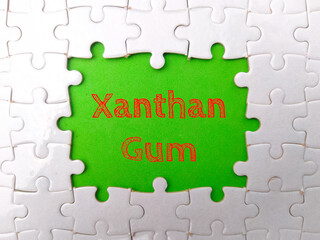 White puzzle with the word Xanthan Gum on a green background.