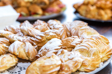 Appetizing fresh pastries on the buffet table. Catering for business meetings events and holidays. Close-up.
