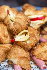 Appetizing fresh sandwich croissants. Business meetings, events and snacks for the holidays. Close-up. Vertical. Selective focus.