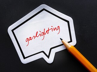 Pencil writing on speech sticker GASLIGHTING, manipulation game in which abuser attempts to create...