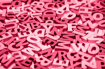 Abstract black and white background of wooden letters of the Latin alphabet. Concept: back to school, literacy and reading, language learning. Selective focus