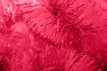 Abstract Christmas tinsel in trendy color viva magenta for 2023