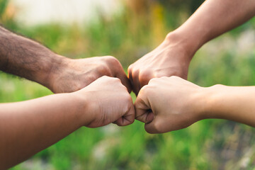 People putting their hands together. Friends making group fist bump. unity and teamwork. Friendship happiness leisure partnership team concept.