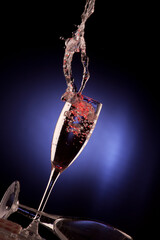 Glasses of champagne with splash, isolated on black