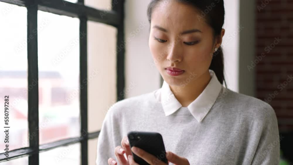 Poster mobile, communication and business with an asian woman typing a text message in her office at work. 