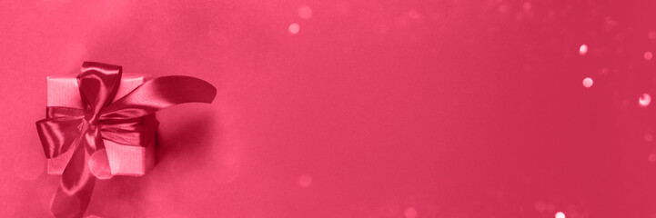 Gifts in kraft paper with magenta ribbon.