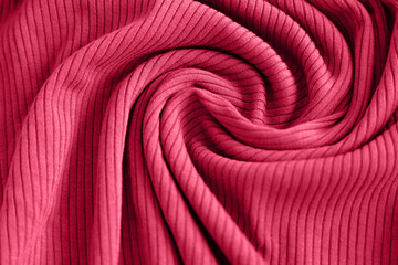 Fototapeta na wymiar Viva magenta color of the year 2023, ribbed texture of cloth. Fabric textile pattern.