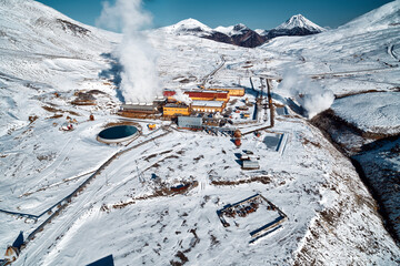 Aerial view to geothermal power plant in mountain. Clean green renewable energy in Kamchatka. - 550799855