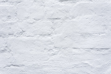 Texture of an old brick wall painted with white dye