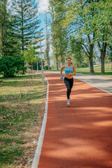 Female athlete running on a sports track