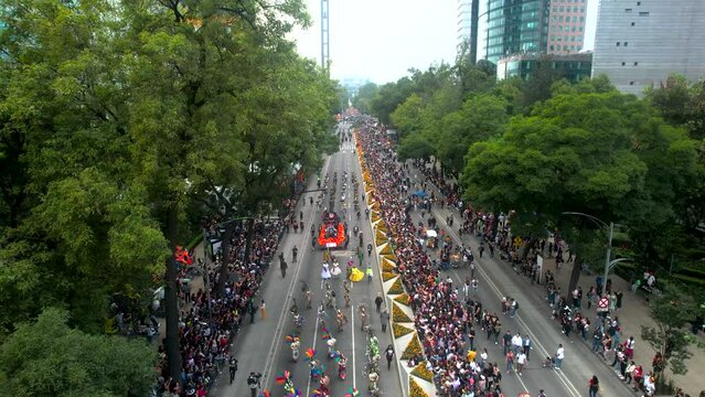 aerial drone shot of various artistic representations during day of the dead parade in mexico city