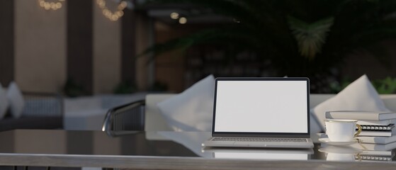 Laptop screen mockup on stylish tabletop over blurred restaurant or coffee shop seating space