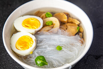 Fototapeta na wymiar soup rice noodles funchose, egg, mushrooms Pho Bo delicious snack healthy meal food snack on the table copy space food background rustic top view