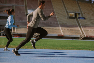 Friends jogging on a sports track