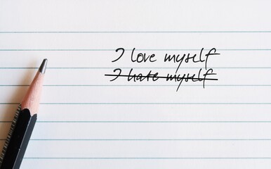 Pencil on note paper with handwritten text I HATE MYSELF, change to I LOVE MYSELF, concept of overcoming self-hatred feeling and focus on positivity, boost self worth for healthy mentality