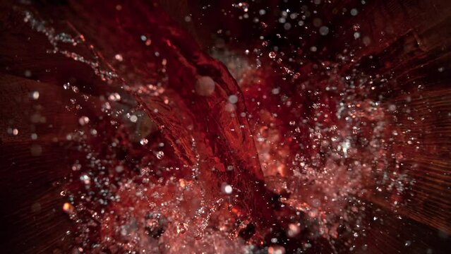 Super Slow Motion Shot of Pouring Red Wine into Old Oak Wooden Barrel at 1000fps.