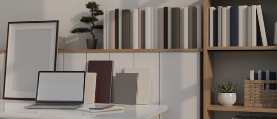 Minimalist white home working space with laptop mockup, books, decor plant and frame mockup