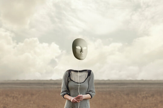 surreal headless person holds a hanging mask from a string