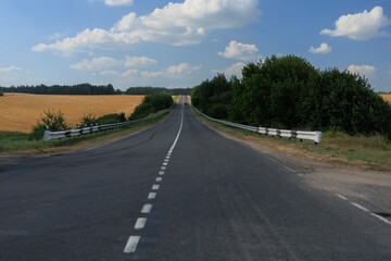 Naklejka premium Highway wide road, transport and blue sky with clouds on a summer day