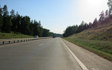 Highway wide road, transport and blue sky with clouds on a summer day