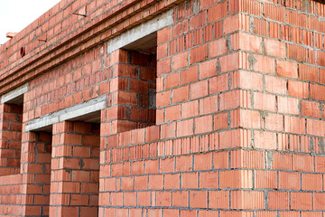 Construction of ceramic brick walls. Keramoblock. Hollow brick. Construction of a red brick house. Close-up. Material for the construction of walls and partitions.