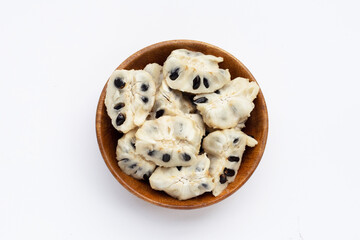 Custard apple in wooden bowl on white background.