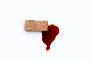 Brick with blood on white background.