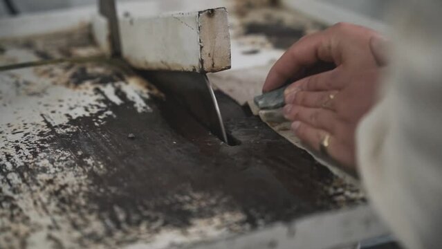 Craftsman hand cutting jade stone, close up view