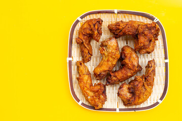 Fried chicken necks on yellow background.