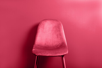 Modern Pink Velour Chair on wooden legs, toned image in viva magenta, color of the year 2023 - obrazy, fototapety, plakaty