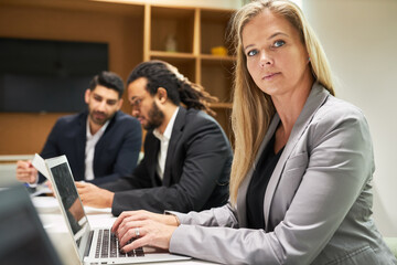 Smiling businessman working on laptop computer
