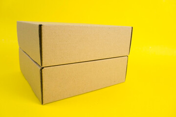 cardboard boxes of various shapes and positions isolated on a yellow background       