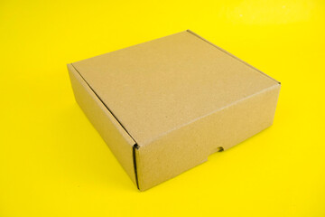 cardboard boxes of various shapes and positions isolated on a yellow background       