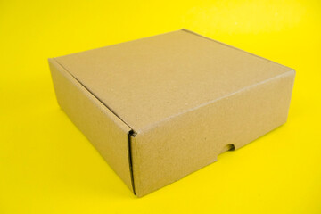 cardboard boxes of various shapes and positions isolated on a yellow background       
