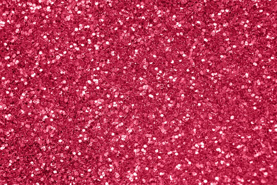 glittering background of red sequins closeup. Sparkle festive texture