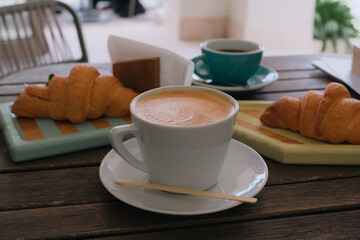 cup of coffee with croissants
