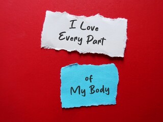 Torn paper on red background with handwritten text I LOVE EVERY PART OF MY BODY, concept of self...
