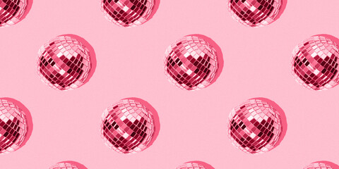 Seamless pattern with mirrored disco balls on a pink background. Image toned in the color of the...