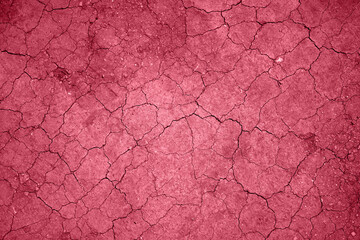 Color of the year 2023, viva magenta red with a copy space, the texture of dry earth with cracks...