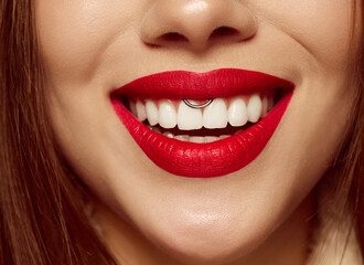 Fototapeta premium Closeup view of female mouth with bright red lipstick. Beautiful wide smile of young woman with great healthy white teeth