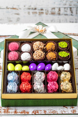 Packed gift chocolate. Pack of mixed chocolates on wood background. close up