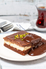Chocolate cake slice. Chocolate and cream cake on wood floor background. close up