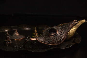 Aladdin's magic lamp isolated on black background