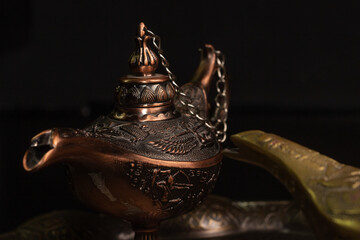 Aladdin's magic lamp isolated on black background