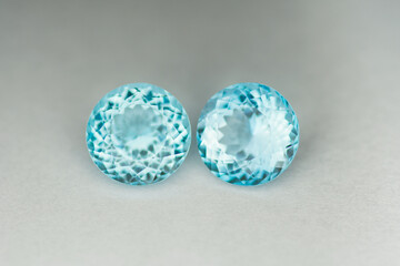 Rich sky blue color topaz matched pair, Swiss blue topaz gemstone round settings on light gray...