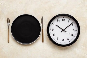 Time to eat - meal time concept. Round wall clock with plate