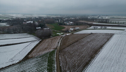 First autumn snow in a rural field - top view